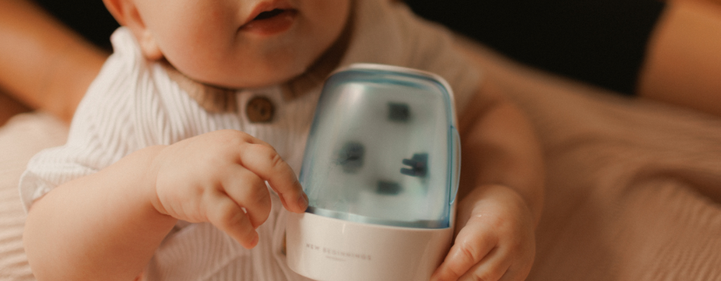 baby holding uv steriliser