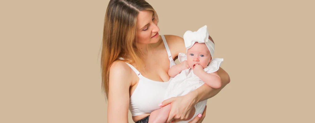 new mother wearing a maternity bra and lying beside baby
