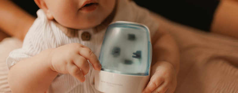baby holding uv steriliser