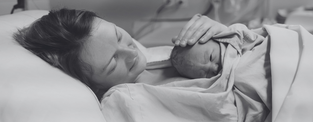 mum cuddling newborn baby