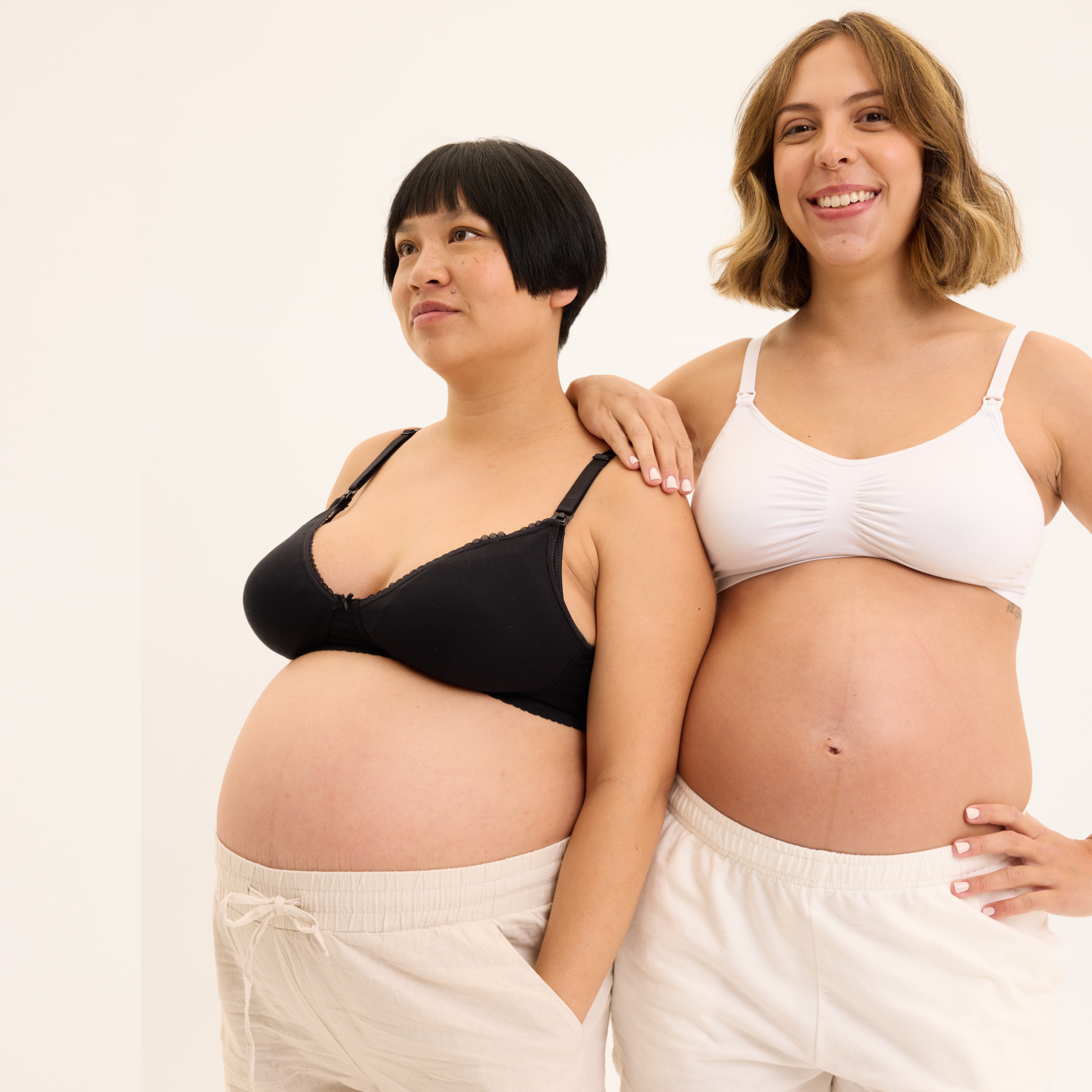 Two pregnant women standing side by side against a white background

Details
