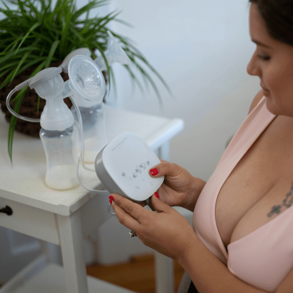 mother wearing Transition maternity Bra and holding pump